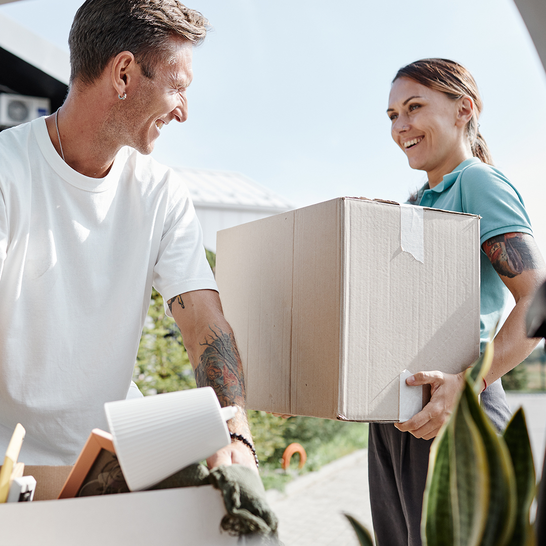 couple loading boxes into a storage unit together