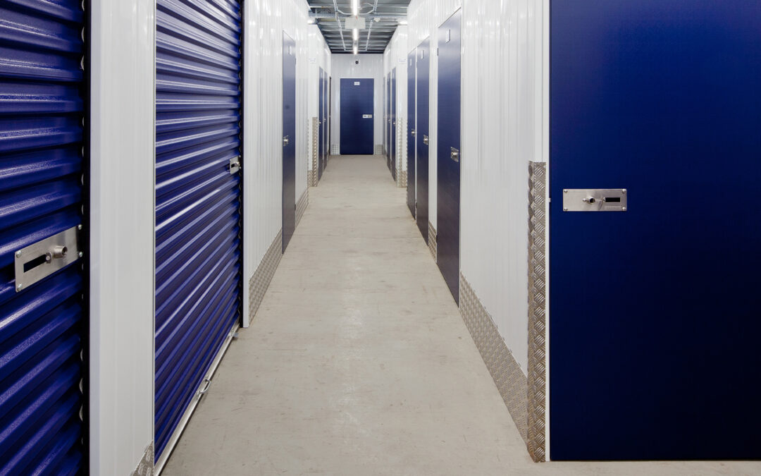 storage unit hall. Dark blue doors and white walls.