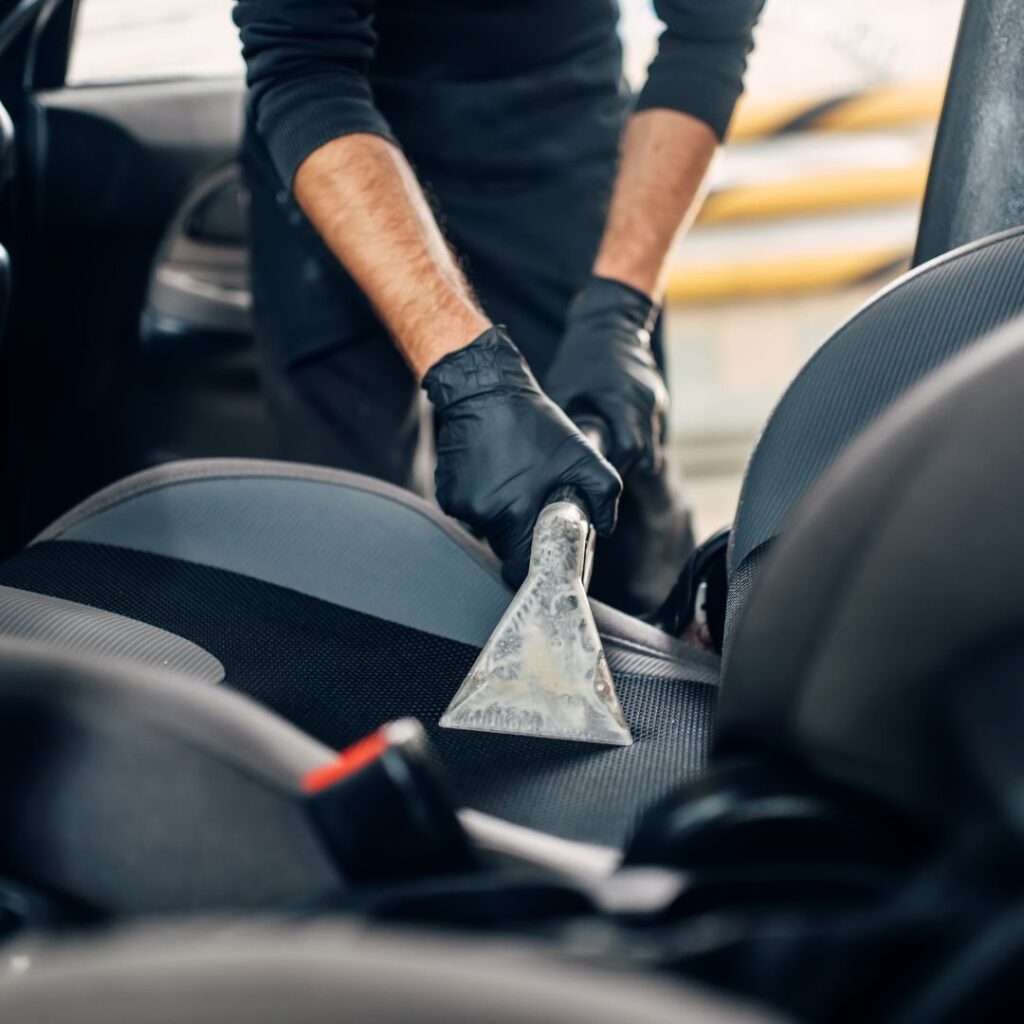 person cleaning the car interior