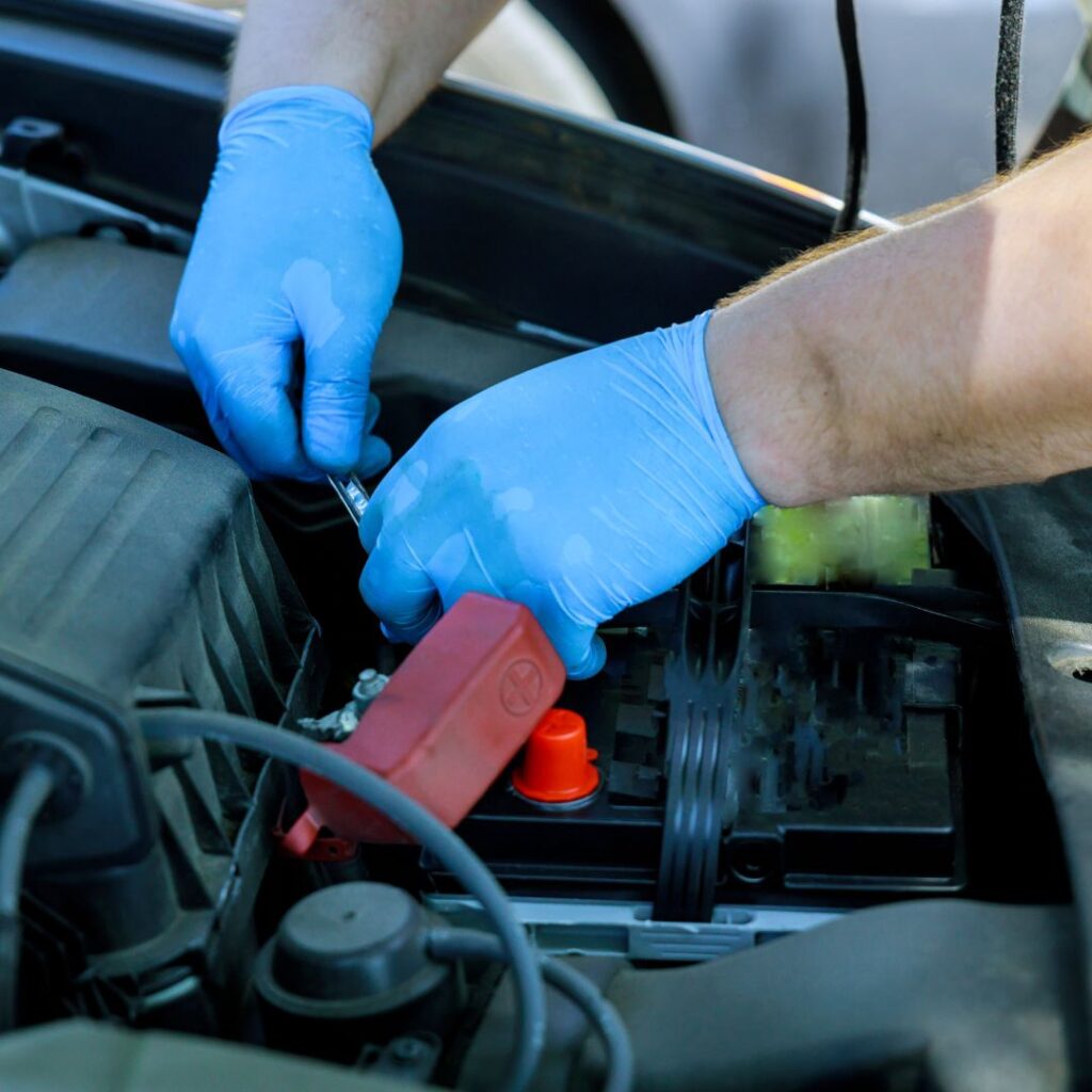 person disconnecting a battery