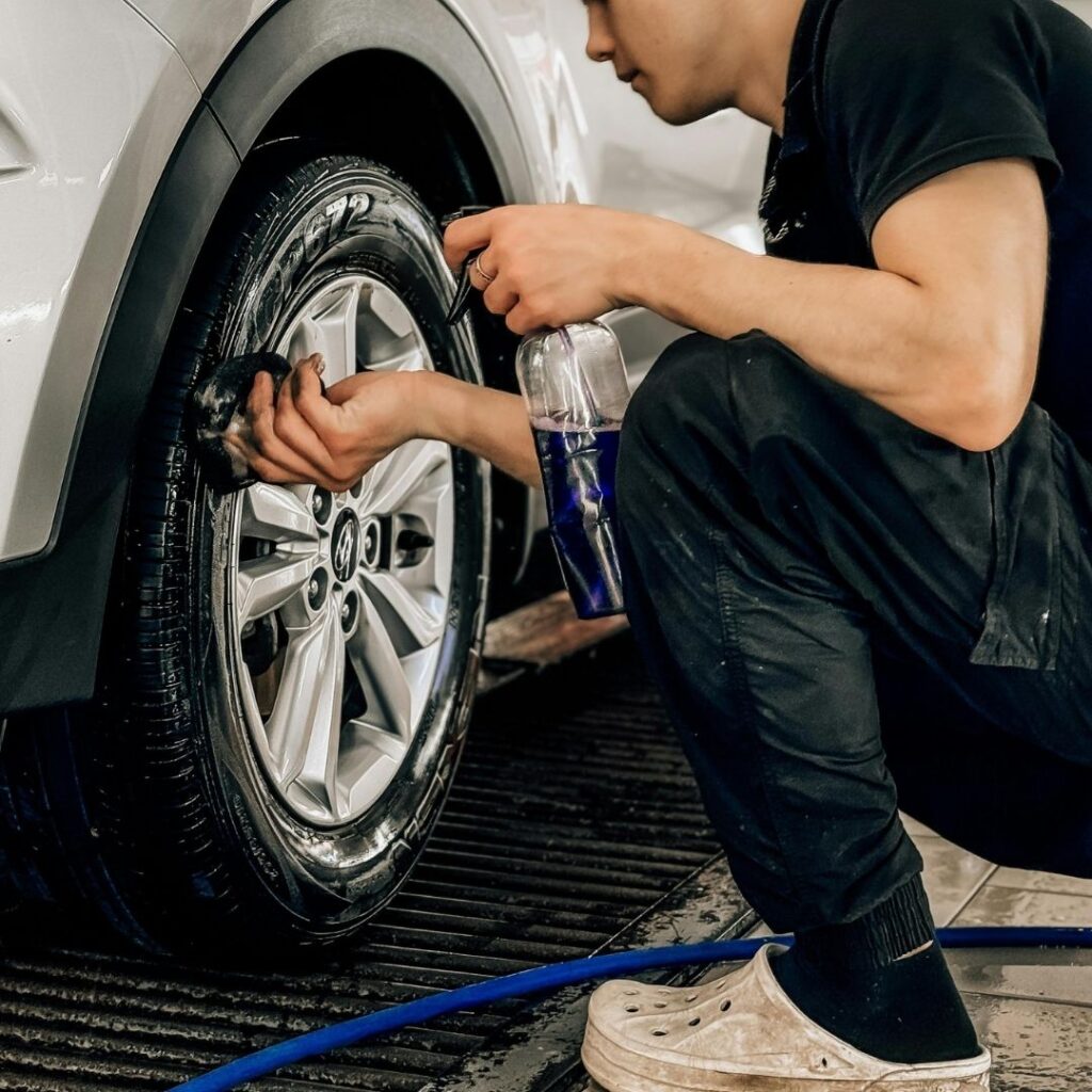 person cleaning his tires